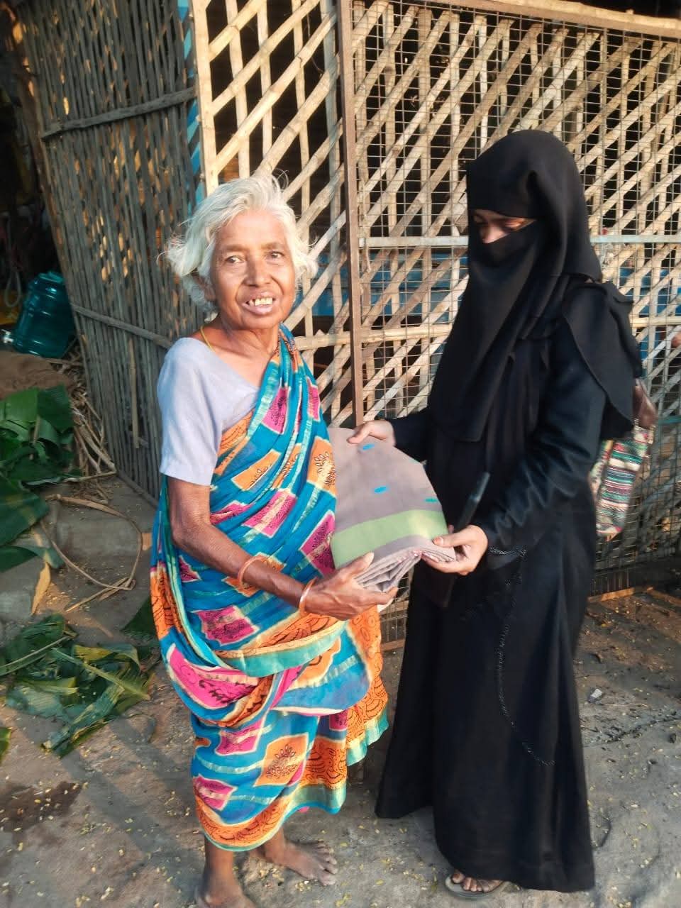 Saree being handed over during clothes distribution
